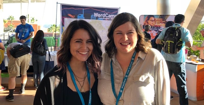 Image of Caity Kelly and Victoria Cole in front of the WordCamp LA banner in Los Angeles at the WordPress conference