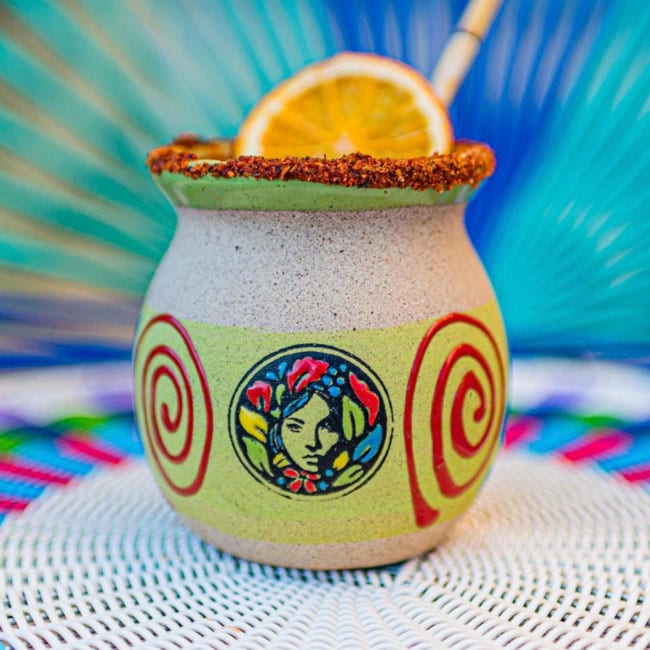 Margarita cup with a que chula logo on it