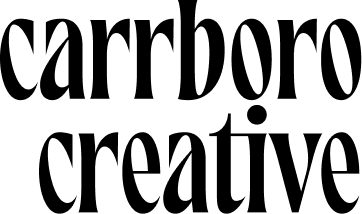 Black text reading “carrboro creative” in a bold, stylized serif font on a light gray background.